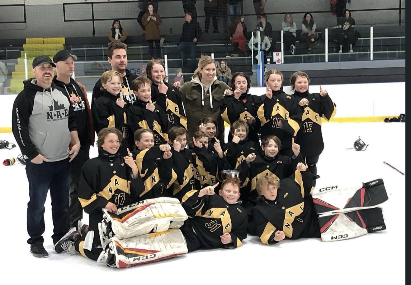 Championship team photo with coaches and trophy